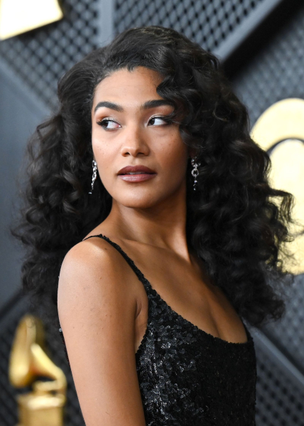 Olivia Dean posing in a sparkly black dress