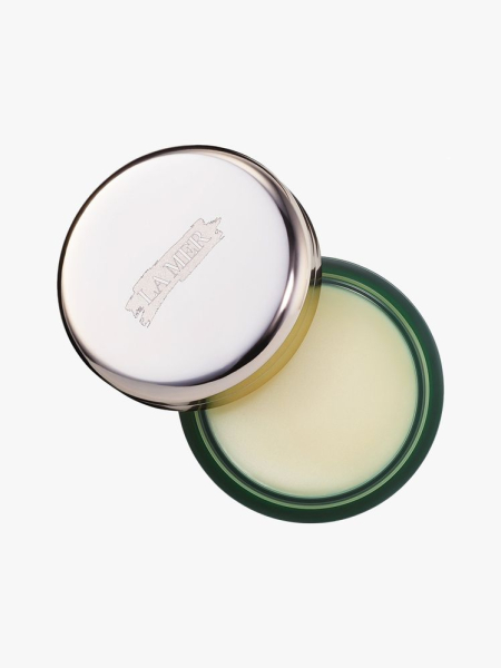 La Mer The Lip Balm top view of a green jar of lip balm with silver cap ajar on light gray background